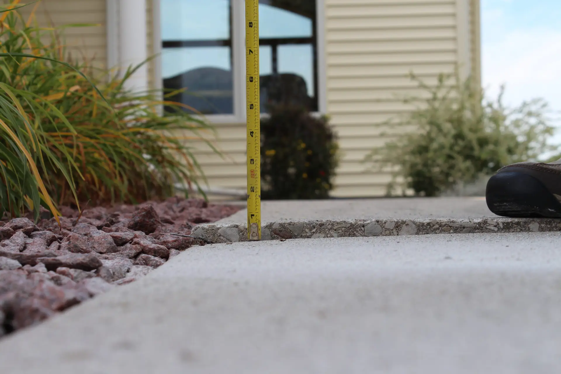 Raised concrete measured with a tape measure